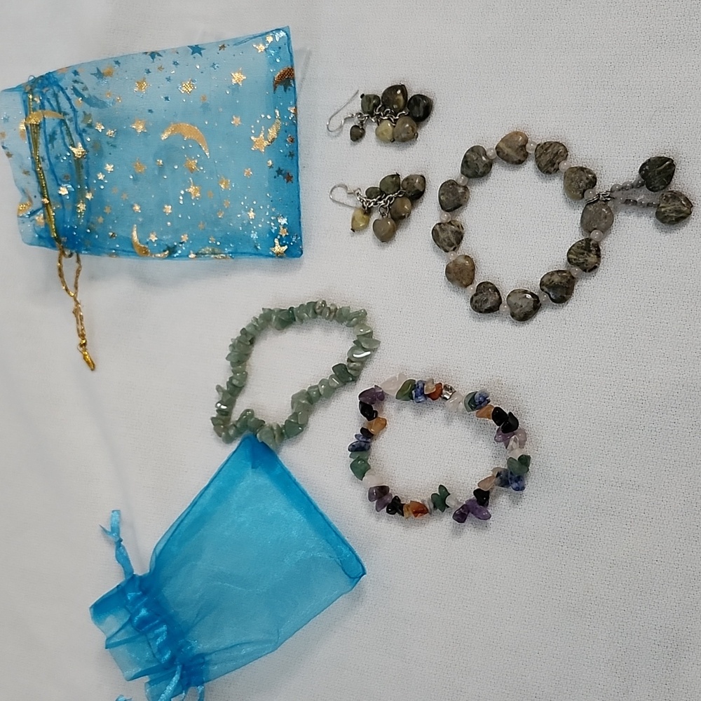 Heart-shaped bracelet, matching dangling earrings, and crystal bracelets